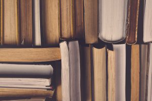 Stack of Used Old Books in the School Library, Toned Cross Processed Image.
